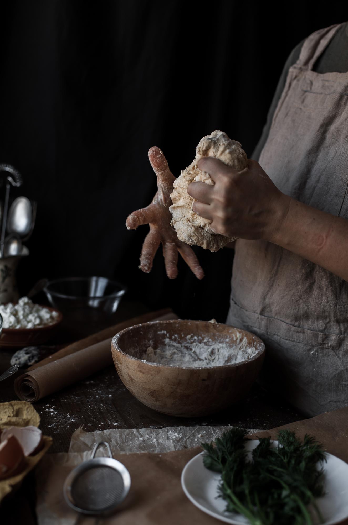 Hands kneading dough in studio kitchen
