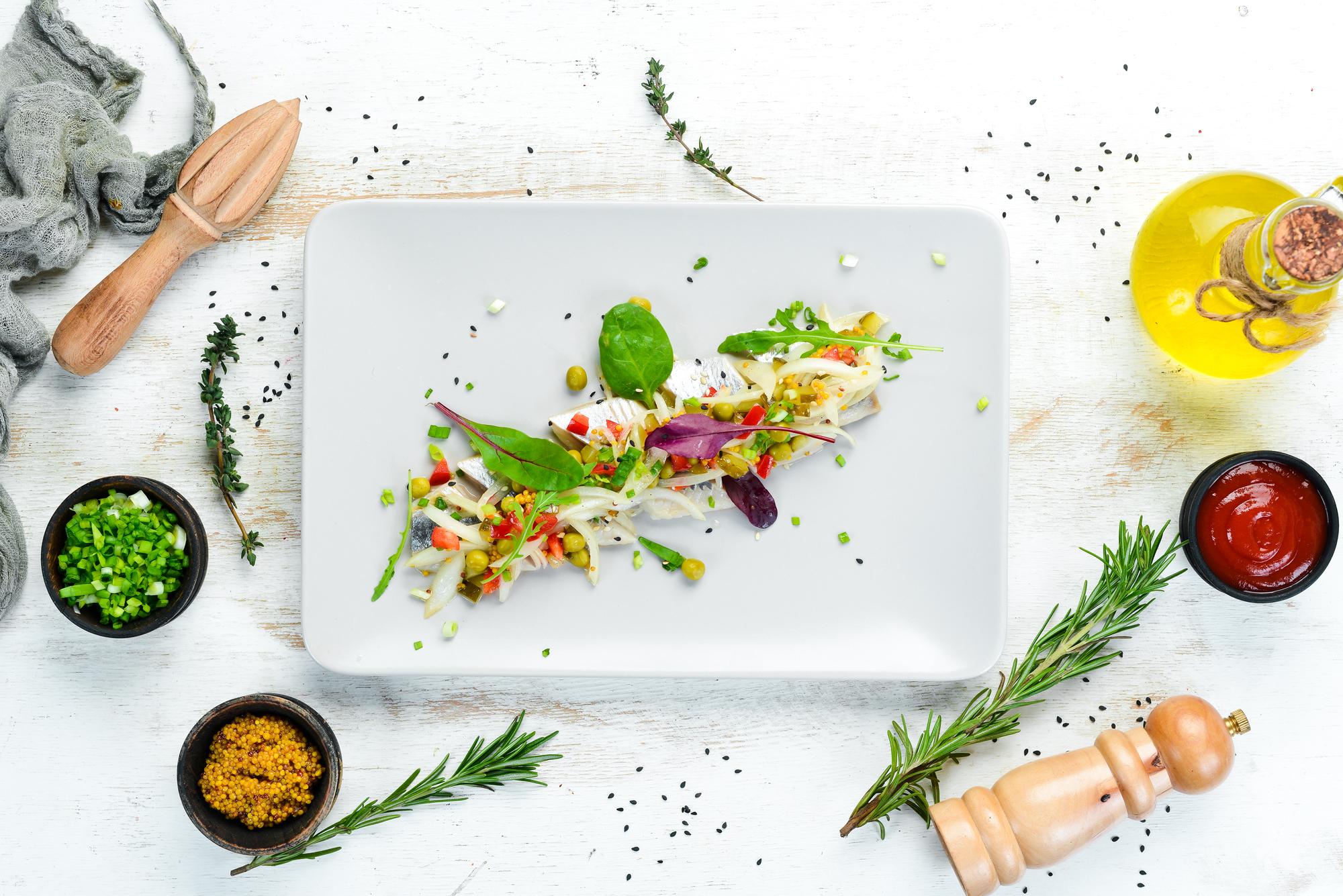 Chef arranging herbs on a wooden board